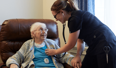 Female doctor attentively using a stethoscope to listen to the chest of a senior woman in a Senior Living Community in PA