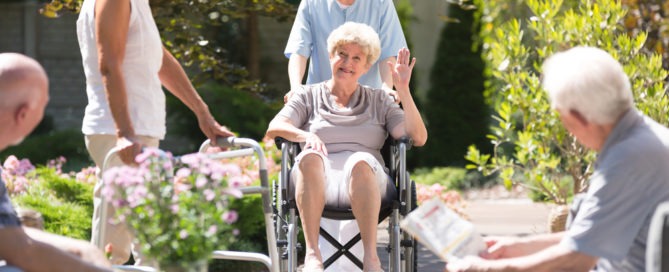 new resident waving to friends at retirement center