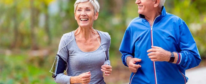 Healthy senior couple jogging and has increased mobility which is one of the benefits of physical therapy for seniors.