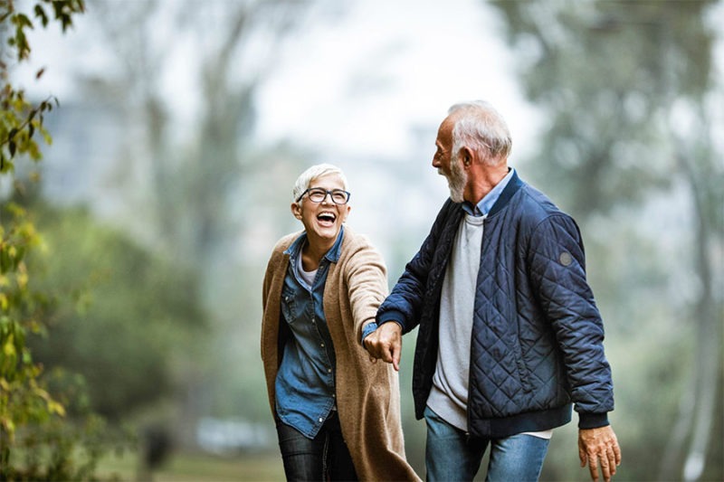 Senior couple happy walking together and has peace of mind due to advance care planning.