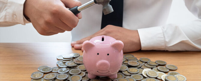 Smashing a piggy bank concept of financial planning affected by myths of retirement