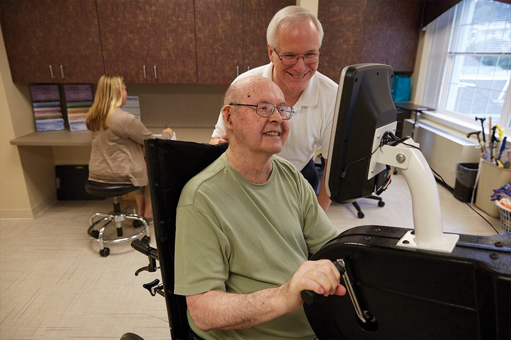 Senior man actively participating in rehabilitation therapy in an environment that promotes his well-being and interest.